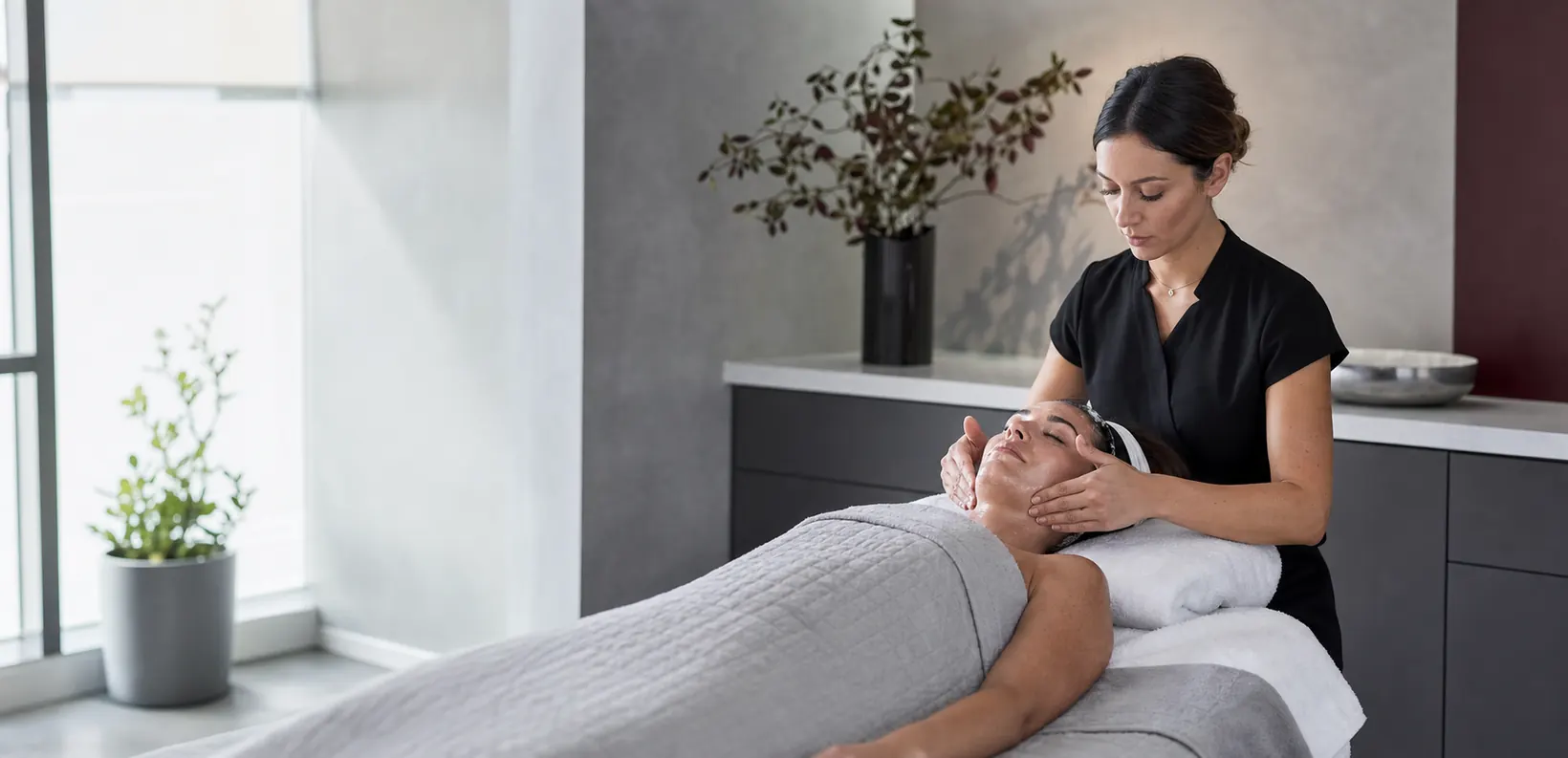A client receiving a facial treatment in a modern beauty salon